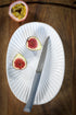 Couteau Bon Appétit+ anthracite sur une assiette blanche
